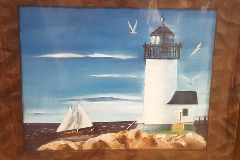 Photograph of framed lighthouse painting