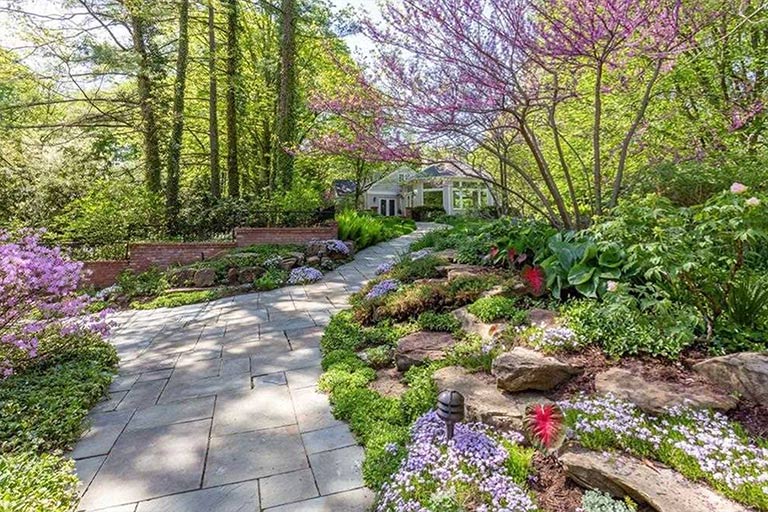 Gorgeously landscaped front yard with blooming trees and shrubs